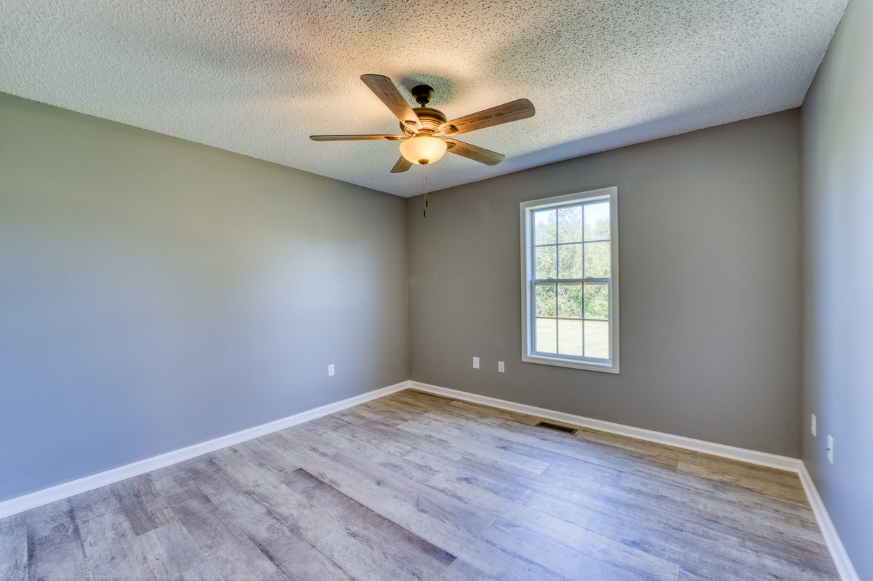1464 Little Dry Creek Road Pulaski, TN 38478 - Photo 20 of 26 wooden floor in an empty room with a window