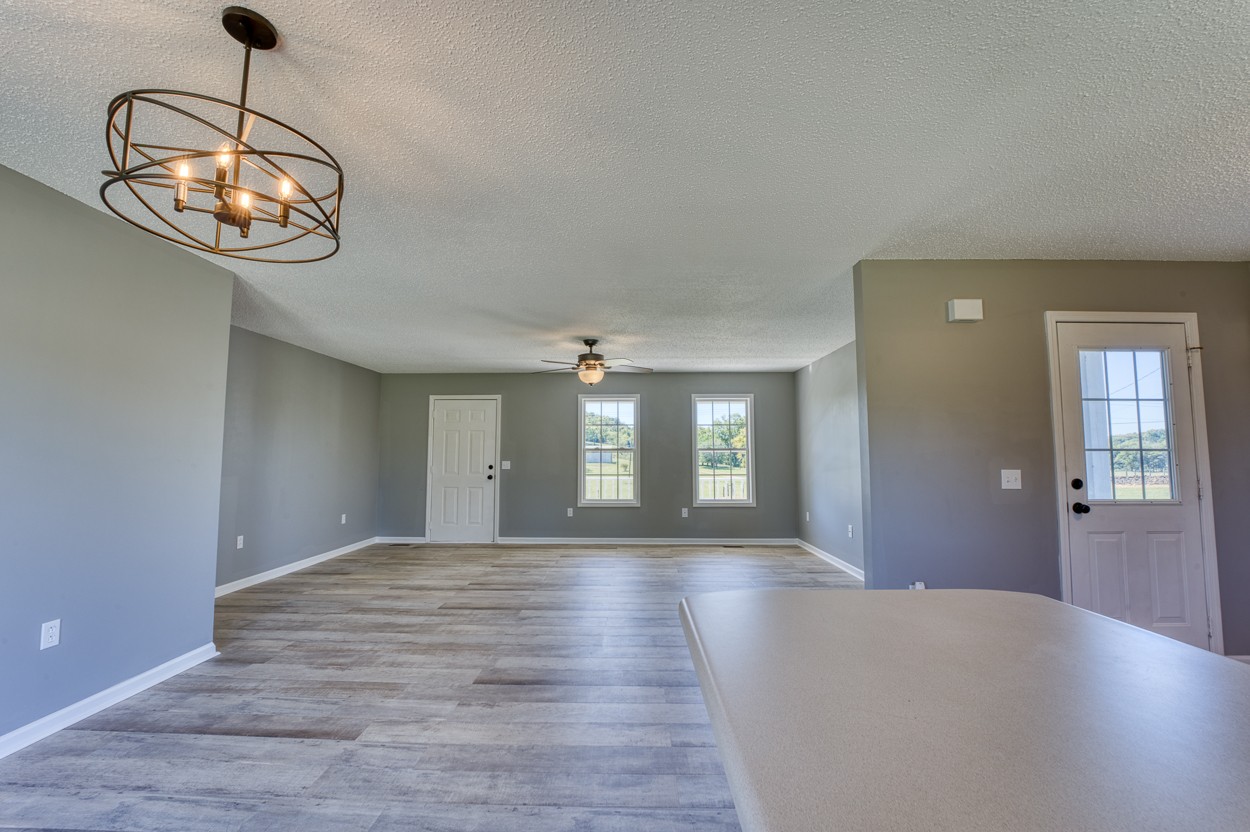 1464 Little Dry Creek Road Pulaski, TN 38478 - Photo 9 of 26 an empty room with wooden floor and windows