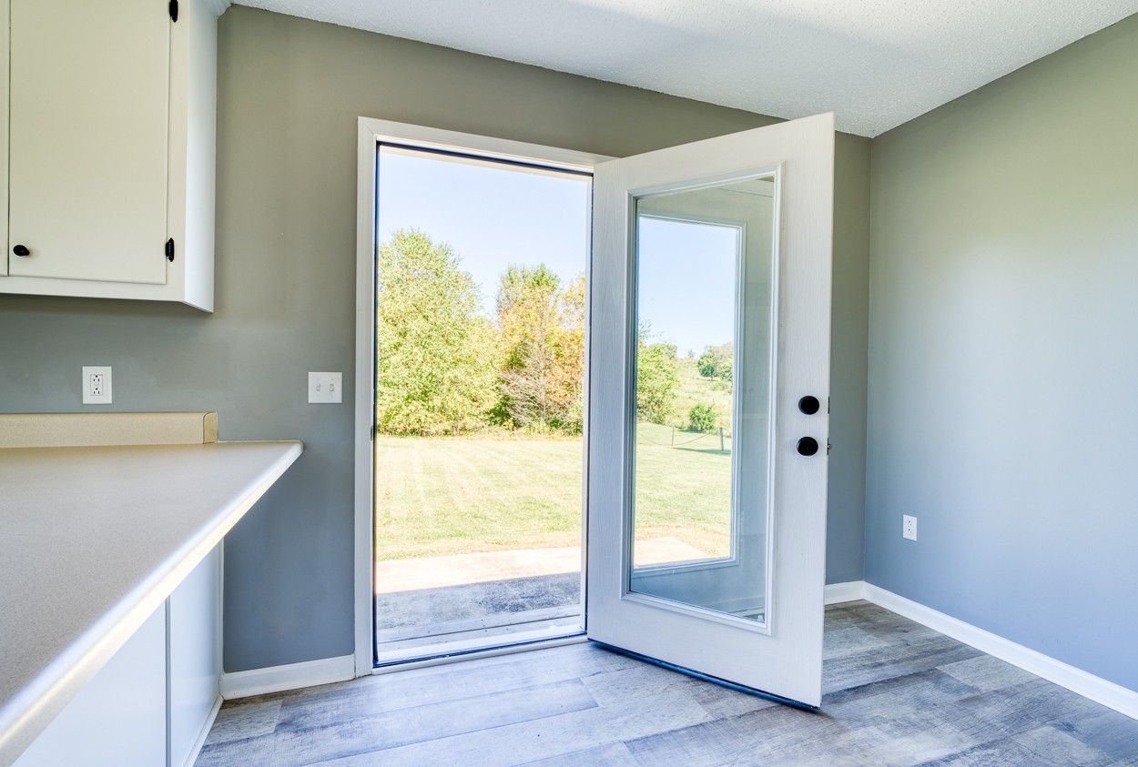 1464 Little Dry Creek Road Pulaski, TN 38478 - Photo 10 of 26 a view of an empty room with wooden floor and a window