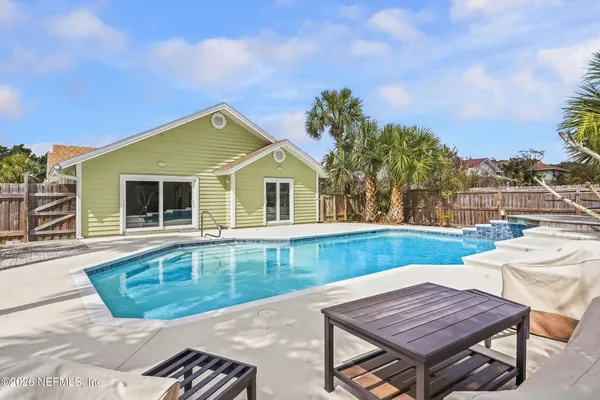 a view of a house with backyard and sitting area