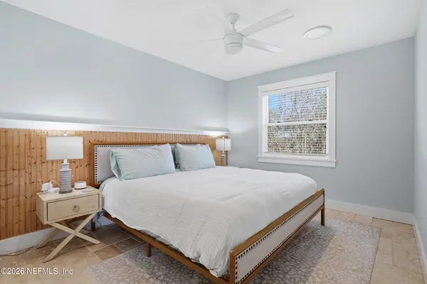 a bedroom with a bed and window