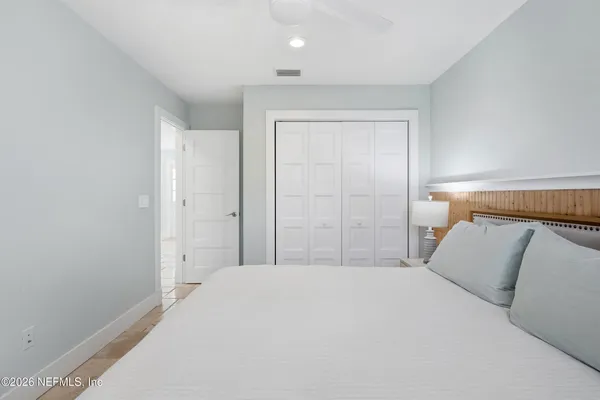 a bedroom with a bed and a night stand