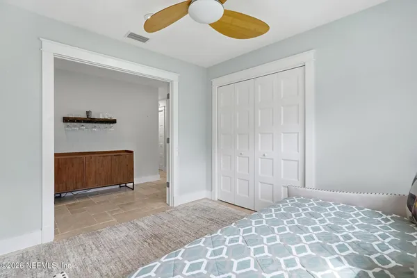 a bedroom with a bed and a dresser