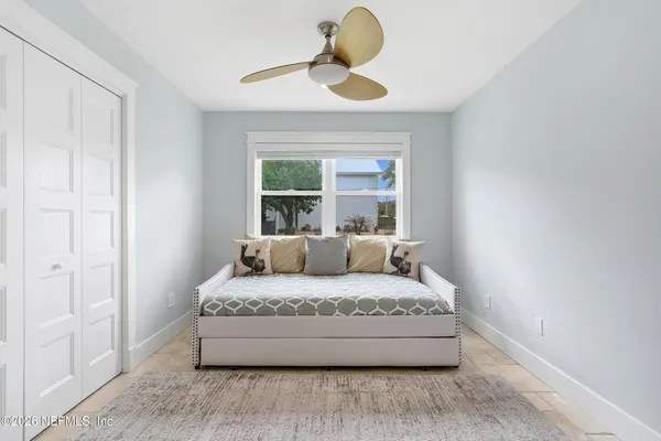 a living room with a bed furniture and a window
