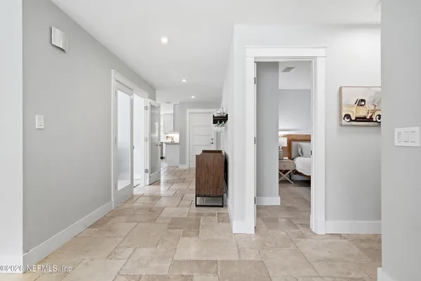 a view of a hallway and a livingroom with furniture