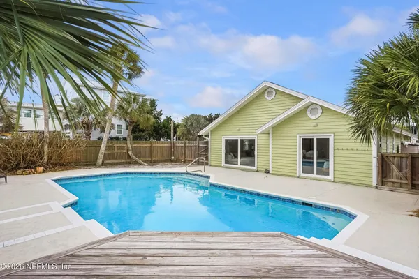 a view of a house with pool and sitting area