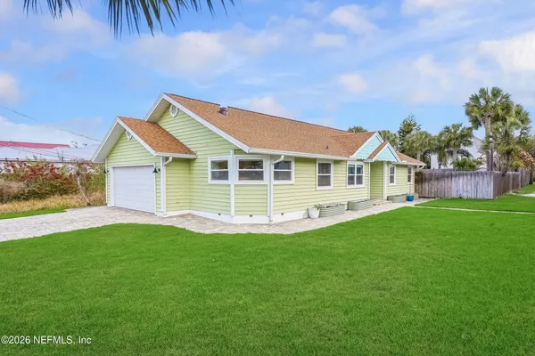 a view of a house with a yard and deck
