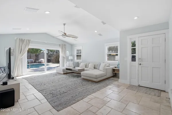 a living room with furniture and a flat screen tv