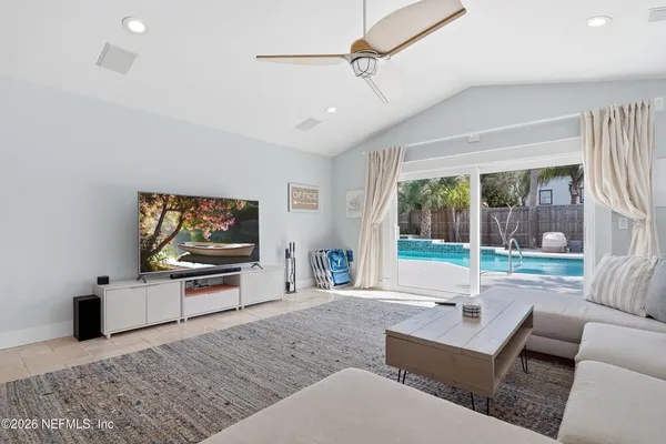 a living room with furniture and a flat screen tv
