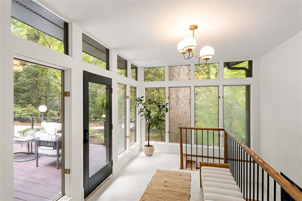 922 Barton Woods Road Northeast Atlanta, GA 30307 - Photo 12 of 96 a view of a dining room with wooden floor windows and outdoor view