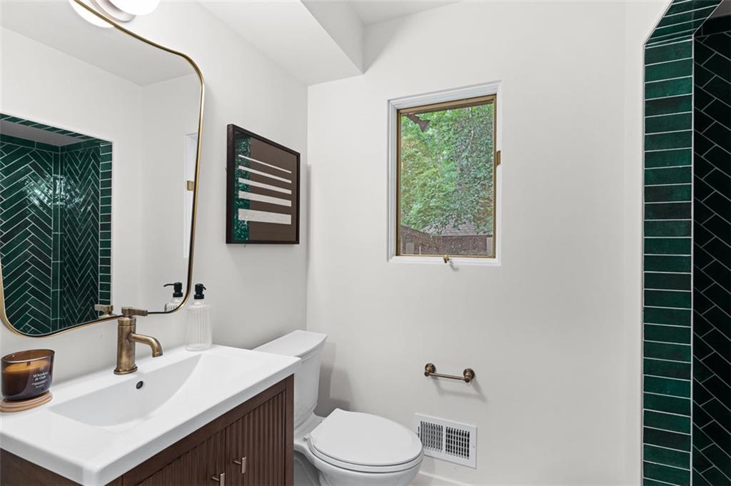 922 Barton Woods Road Northeast Atlanta, GA 30307 - Photo 47 of 96 a bathroom with a sink toilet and mirror