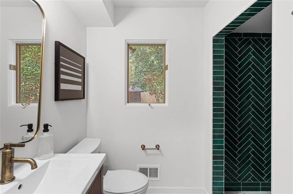922 Barton Woods Road Northeast Atlanta, GA 30307 - Photo 48 of 96 a bathroom with a toilet a sink and mirror