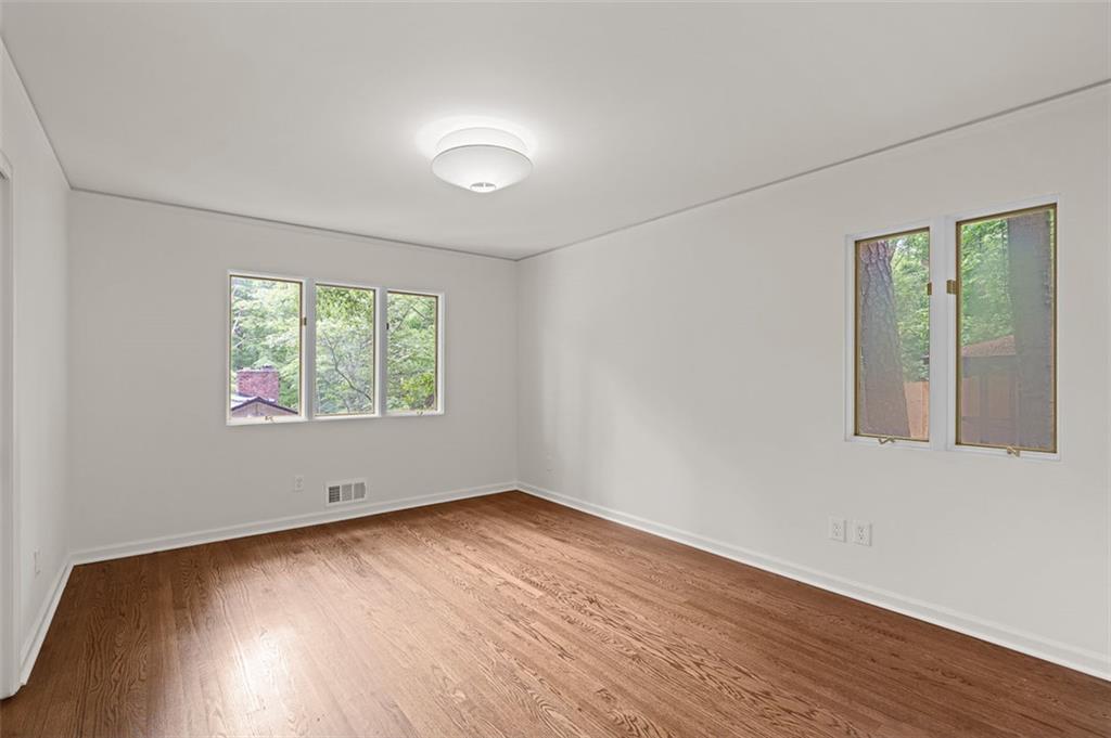 922 Barton Woods Road Northeast Atlanta, GA 30307 - Photo 53 of 96 an empty room with wooden floor and windows