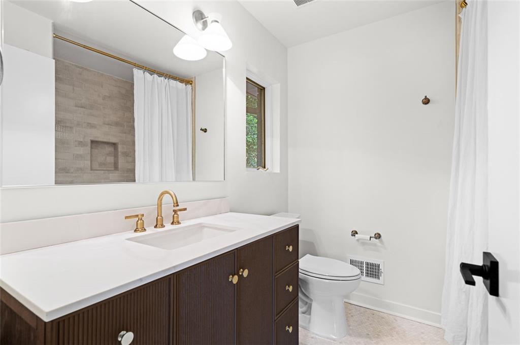 922 Barton Woods Road Northeast Atlanta, GA 30307 - Photo 55 of 96 a bathroom with a sink a toilet and a mirror