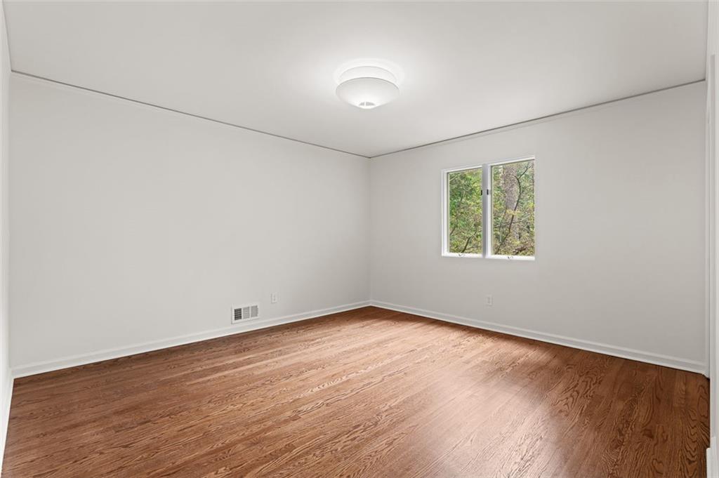 922 Barton Woods Road Northeast Atlanta, GA 30307 - Photo 57 of 96 an empty room with wooden floor and windows