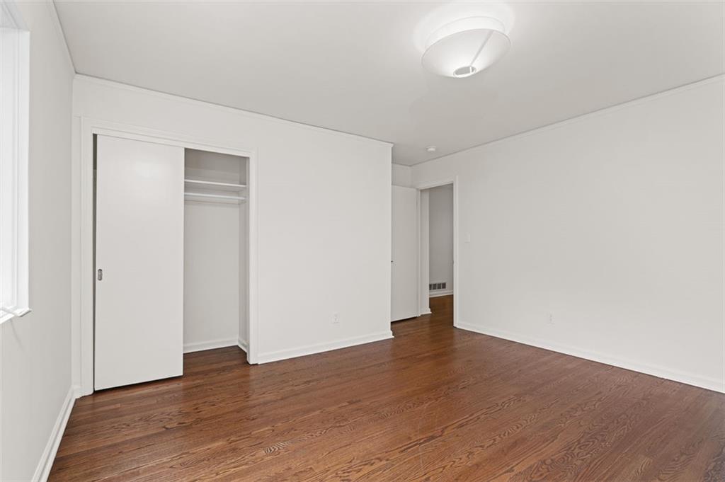 922 Barton Woods Road Northeast Atlanta, GA 30307 - Photo 58 of 96 a view of an empty room with wooden floor and closet