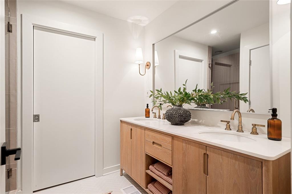922 Barton Woods Road Northeast Atlanta, GA 30307 - Photo 61 of 96 a bathroom with a sink a potted plant and a mirror