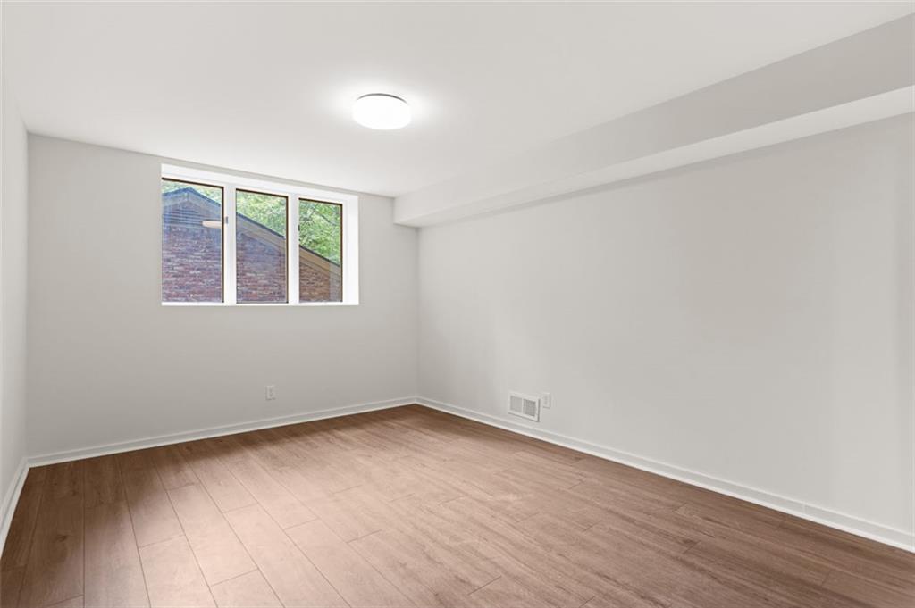 922 Barton Woods Road Northeast Atlanta, GA 30307 - Photo 86 of 96 wooden floor in an empty room with a window