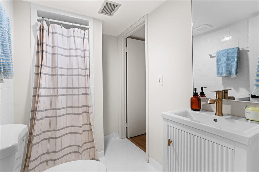 922 Barton Woods Road Northeast Atlanta, GA 30307 - Photo 87 of 96 a bathroom with a sink and a mirror