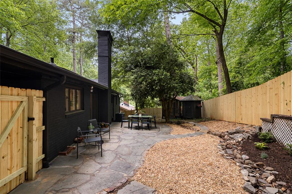 922 Barton Woods Road Northeast Atlanta, GA 30307 - Photo 90 of 96 a backyard of a house with table and chairs