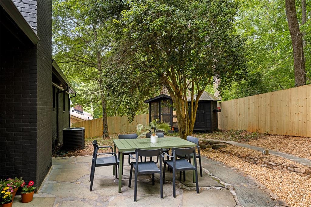 922 Barton Woods Road Northeast Atlanta, GA 30307 - Photo 91 of 96 a view of a chairs and table in backyard