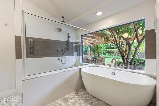 a bathroom with a bathtub and a shower