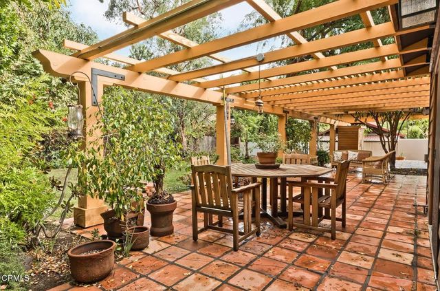 a view of a patio with table and chairs and potted plants