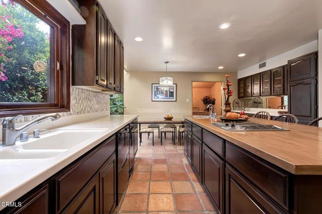 a kitchen with stainless steel appliances a sink stove and cabinets