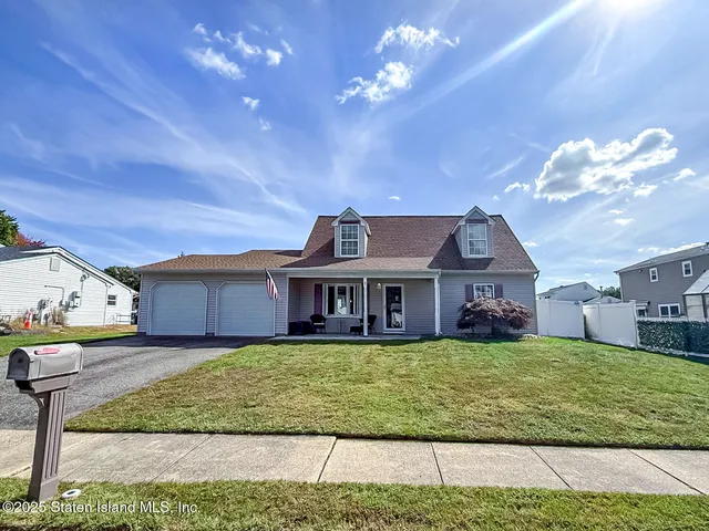 a view of a house with a big yard and potted plants