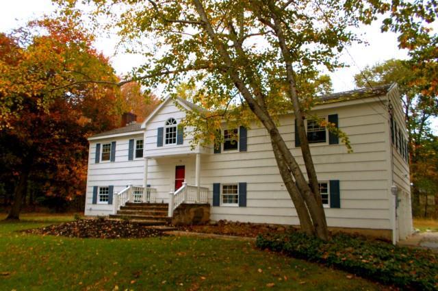 50 Olmstead Lane Ridgefield, CT 06877 - Photo 1 of 1 a view of a white house next to a yard with big trees