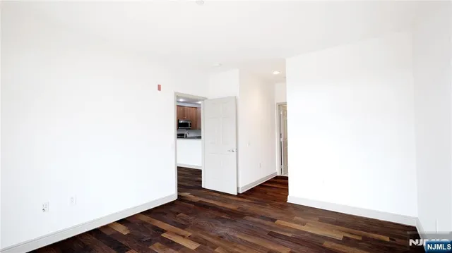 a view of a room with wooden floor