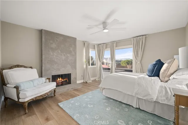 a bedroom with a large bed couch and a fireplace