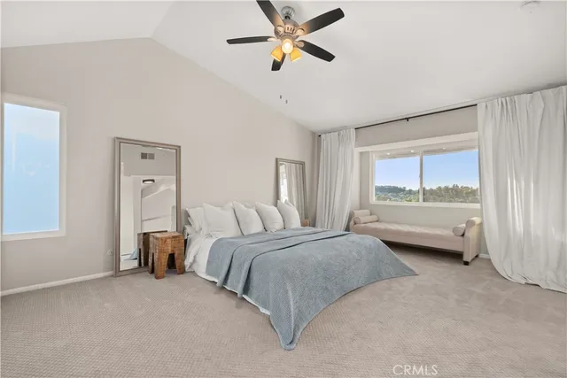 a bedroom with a bed and a large window