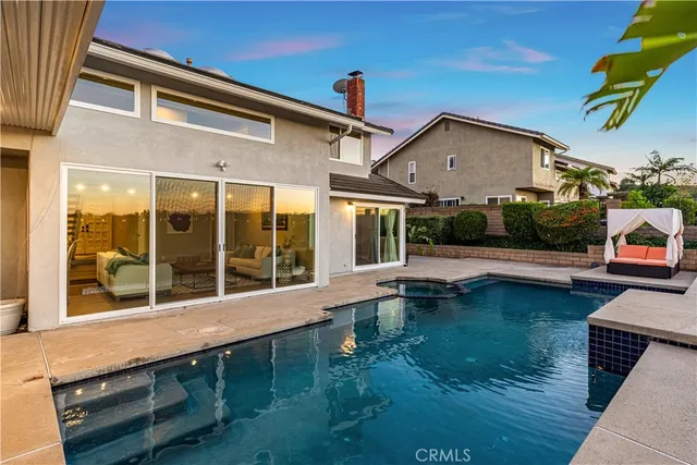 a view of house with swimming pool outdoor seating