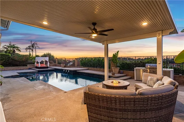 a view of a roof deck with couches and pool
