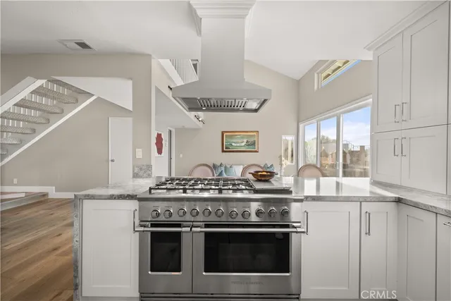 a kitchen with stainless steel appliances granite countertop a stove and a sink
