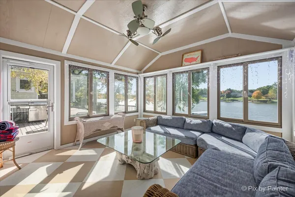 a living room with furniture and large windows
