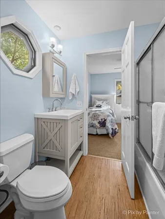 a en suite bathroom with a toilet a sink and a mirror