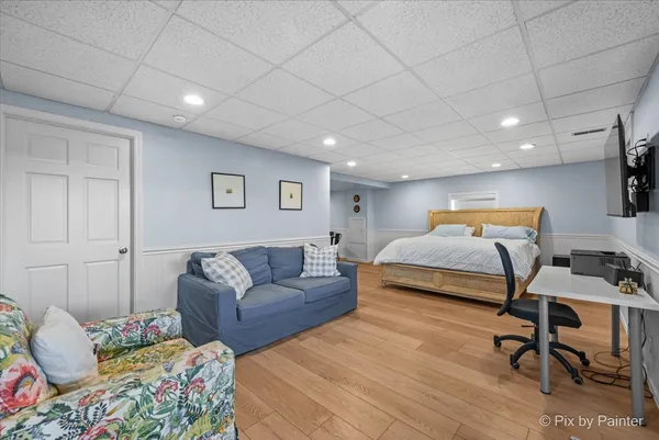 a bedroom with furniture and a wooden floor