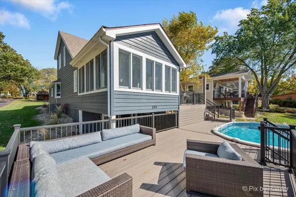 a view of a house with couches chairs and a fire pit