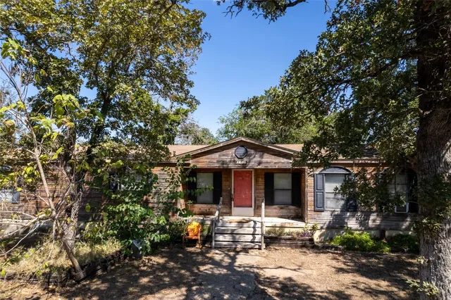 a front view of a house with sitting area and garden