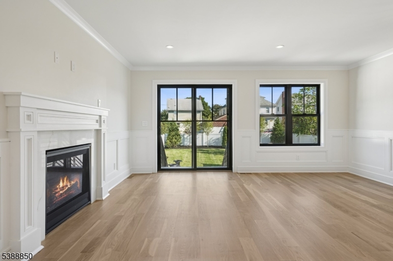 27 Willow Street, Unit A Millburn, NJ 07041 - Photo 11 of 50 a view of an empty room with a fireplace and a window