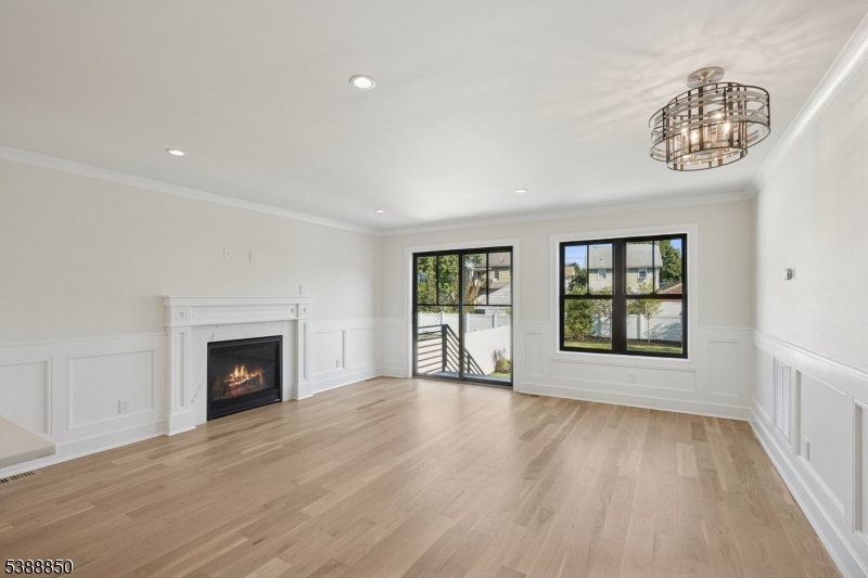 27 Willow Street, Unit A Millburn, NJ 07041 - Photo 12 of 50 wooden floor fireplace and windows in an empty room