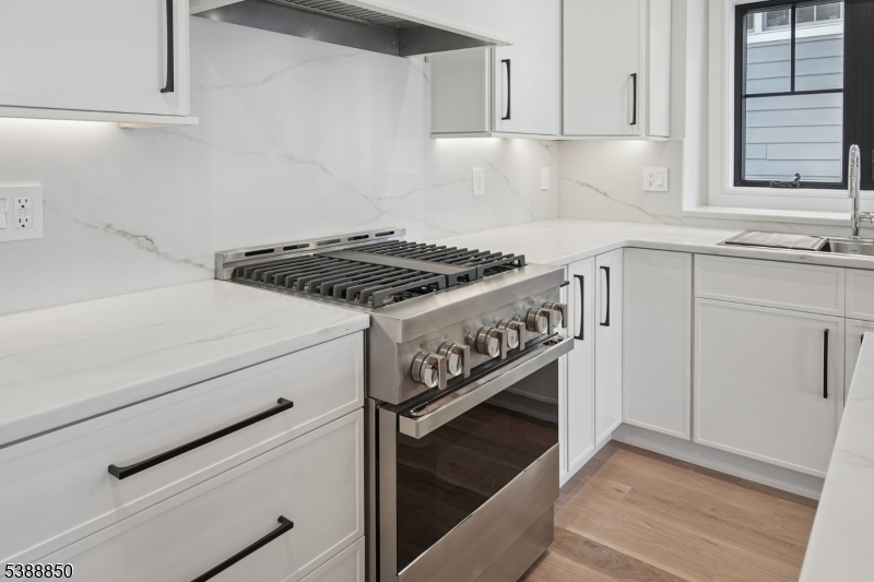 27 Willow Street, Unit A Millburn, NJ 07041 - Photo 18 of 50 a kitchen with granite countertop white cabinets and white appliances