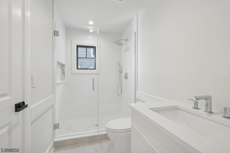 27 Willow Street, Unit A Millburn, NJ 07041 - Photo 21 of 50 a bathroom with a sink a toilet and shower