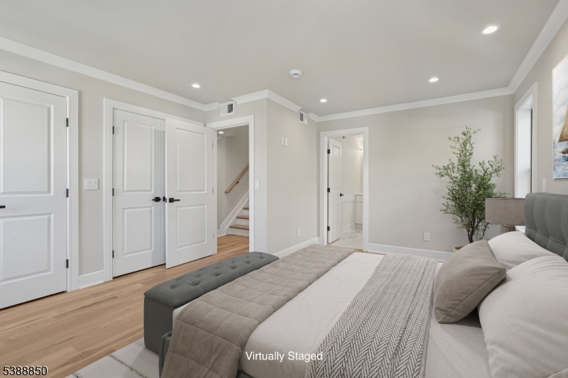 27 Willow Street, Unit A Millburn, NJ 07041 - Photo 22 of 50 a bedroom with a large bed and a chandelier