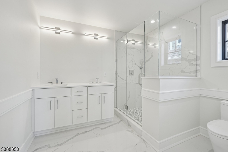 27 Willow Street, Unit A Millburn, NJ 07041 - Photo 26 of 50 a spacious bathroom with a shower sink vanity mirror and toilet