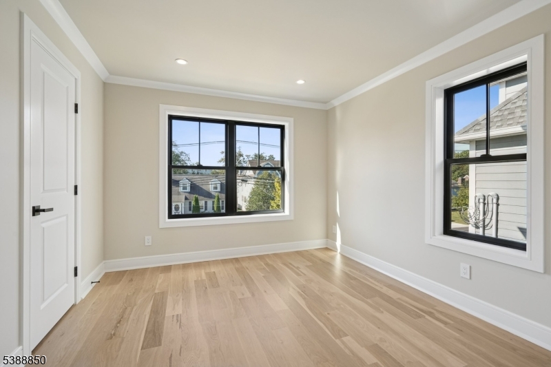 27 Willow Street, Unit A Millburn, NJ 07041 - Photo 32 of 50 a view of an empty room with a window and wooden floor