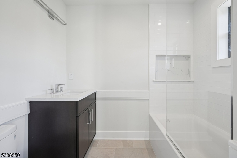 27 Willow Street, Unit A Millburn, NJ 07041 - Photo 33 of 50 a bathroom with a bathtub sink vanity and mirror