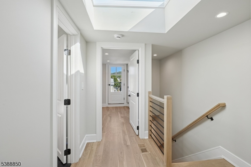 27 Willow Street, Unit A Millburn, NJ 07041 - Photo 35 of 50 a view of a hallway with wooden floor and staircase